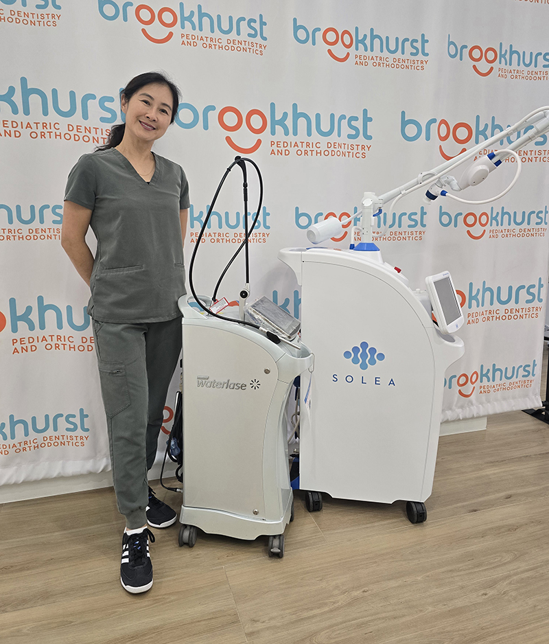 Dentist providing no-drill Solea® laser care for a child